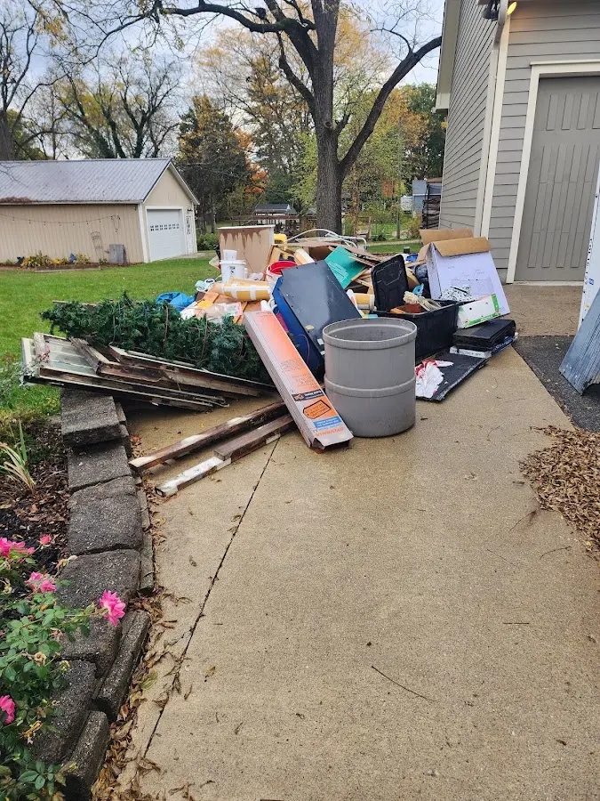Dumpster being loaded with debris for Commercial Dumpster Rental in Stilwell